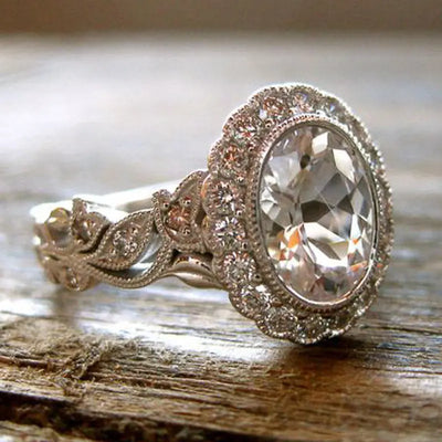Radiant zircon diamond ring with an oval centerpiece and diamond accents, showcasing timeless elegance and sparkle.
